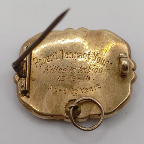 445 - A 19th century yellow coloured metal and black enamel memorial brooch, inset with a lock of hair, la... 