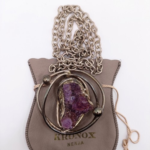 449 - A Kronox silver and uncut amethyst crystal pendant, on a chain, with a branded bag