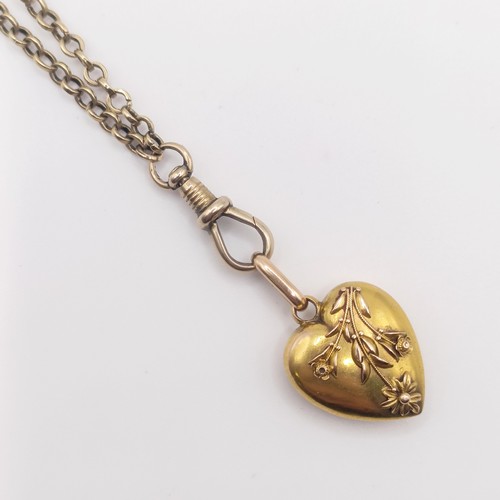 455 - A 15ct gold heart shaped locket, on a yellow coloured metal chain, 11.2 g all in
