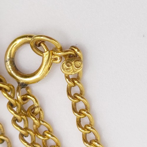 468 - A 9ct gold chain, 3 g, a green stone carved pendant, and a yellow coloured metal chain