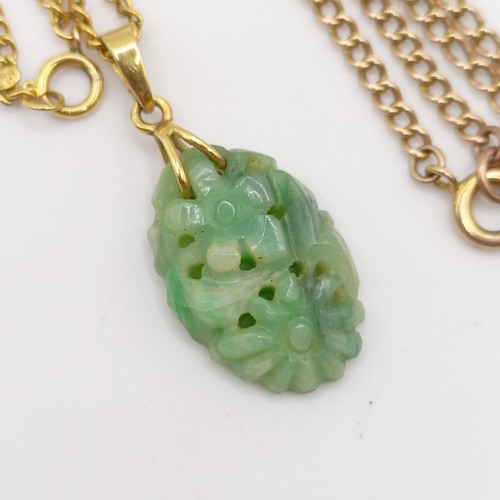 468 - A 9ct gold chain, 3 g, a green stone carved pendant, and a yellow coloured metal chain
