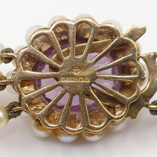 484 - A cultured pearl triple necklace, with a 9ct gold and amethyst clasp