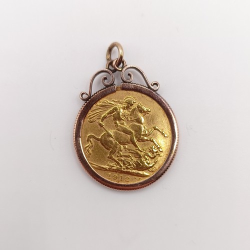 517 - A George V sovereign, 1912, in a yellow coloured metal mount, 9.2 g all in