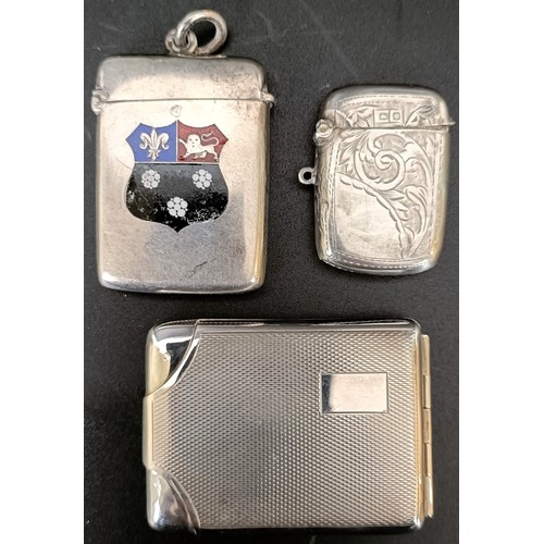 48 - A silver and enamel vesta, decorated a crest in enamel, another, and a matchbox holder, 1.7 ozt