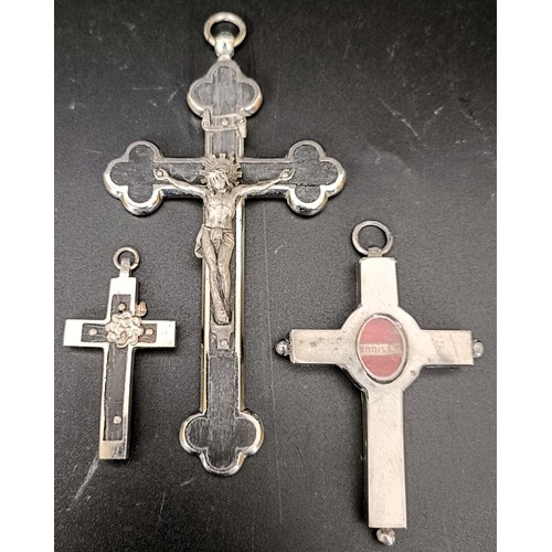 52 - A Continental silver coloured metal and ebony crucifix, 10 cm, a memorial cross, 7 cm, and another c... 