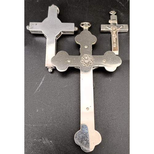 52 - A Continental silver coloured metal and ebony crucifix, 10 cm, a memorial cross, 7 cm, and another c... 