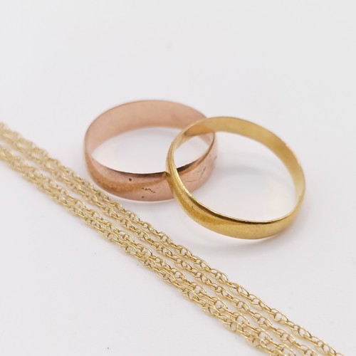 402 - A 22ct gold wedding band, ring size J, 1.4 g, a 9ct gold wedding band, ring size J, 1.3 g, and a yel... 