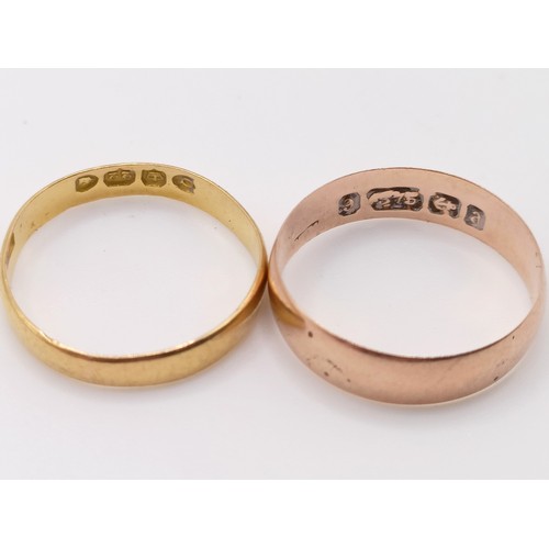 402 - A 22ct gold wedding band, ring size J, 1.4 g, a 9ct gold wedding band, ring size J, 1.3 g, and a yel... 