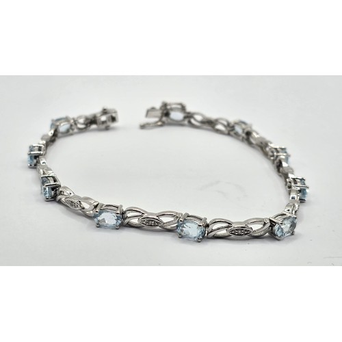 409 - A 9ct white gold, diamond and aquamarine bracelet, .7.6 g all in