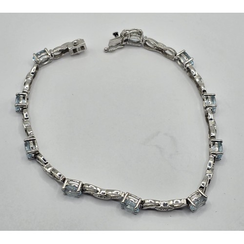 409 - A 9ct white gold, diamond and aquamarine bracelet, .7.6 g all in