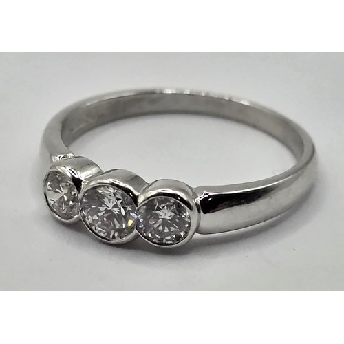 421 - A 18ct white gold and three stone diamond ring, ring size N