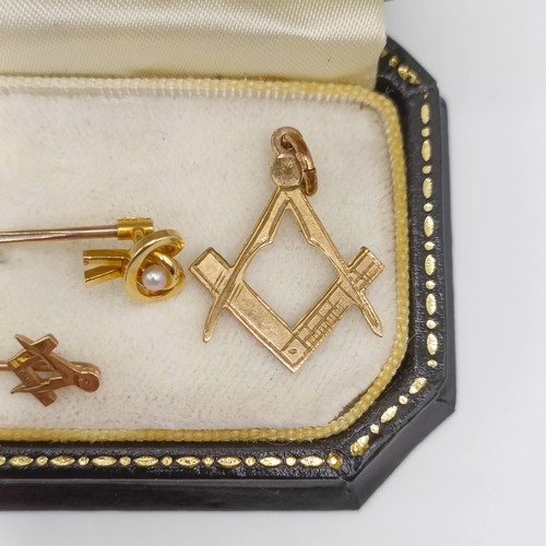 462 - A 9ct gold Masonic pendant, a 9ct gold and seed pearl stick pin, a Masonic stick pin, and a jeweller... 