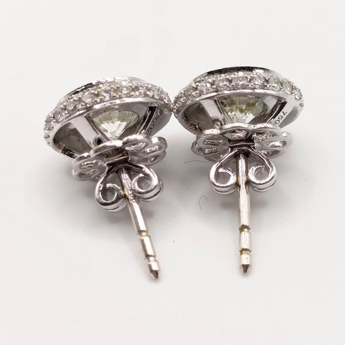 428 - A pair of 18ct white gold and diamond halo earrings, each with a central stone of approx. 1ct