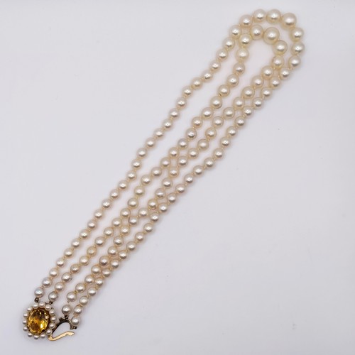 435 - A cultured pearl double necklace, with a 9ct gold and citrine clasp