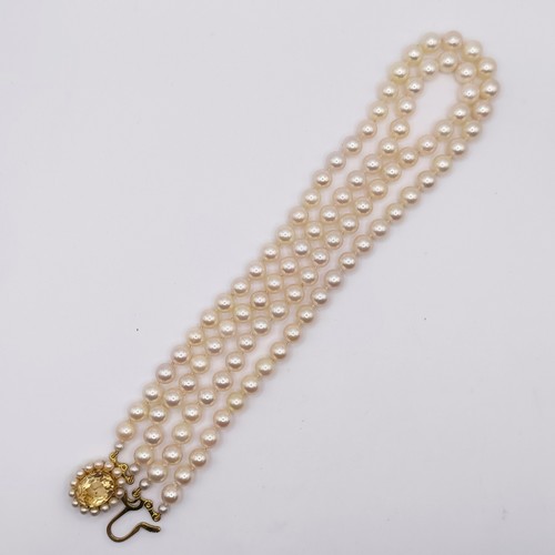 456 - A cultured pearl double necklace, with a 9ct gold and citrine clasp