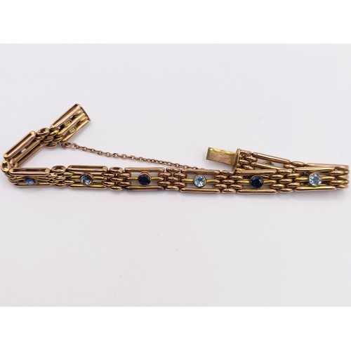 422 - A 9ct gold, aquamarine and sapphire bracelet, 17 g