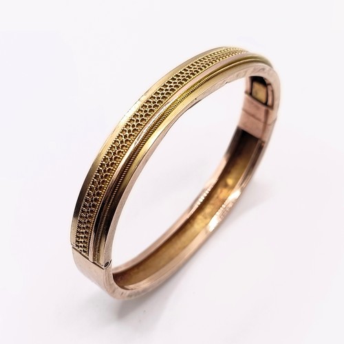 446 - A yellow coloured metal bangle, 13.2 g