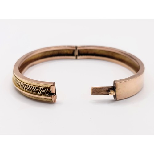 446 - A yellow coloured metal bangle, 13.2 g