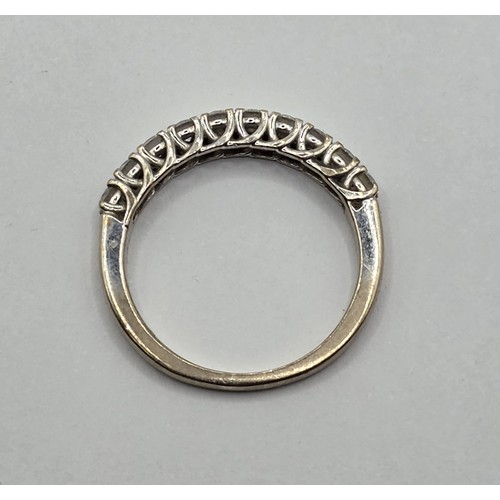 431 - An 18ct white gold and diamond half eternity ring, ring size K