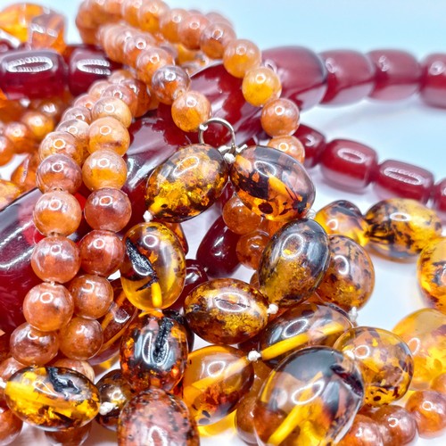 498 - ***Regretfully Withdrawn***A red amber bead necklace and a pair of matching earrings, and two other ... 