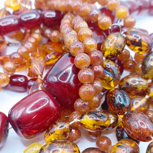 498 - ***Regretfully Withdrawn***A red amber bead necklace and a pair of matching earrings, and two other ... 