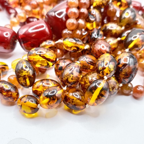 498 - ***Regretfully Withdrawn***A red amber bead necklace and a pair of matching earrings, and two other ... 