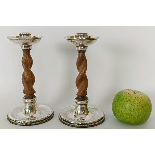 302 - A pair of Arts & Crafts style silver mounted oak barley twist candlesticks, A E Jones, Birmingha...