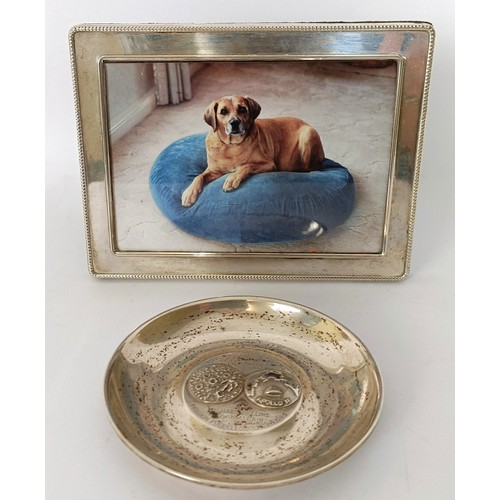 319 - A part table service of plated cutlery, a silver pin dish, and a silver photograph frame...