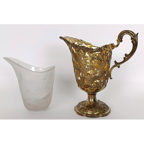 345 - A silver gilt plated milk jug, piered and decorated birds and foliage, with a glass liner, 15 cm hig...