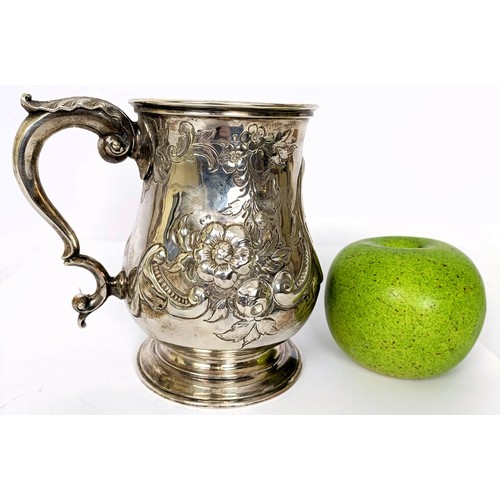 364 - A Victorian silver baluster mug, with embossed decoration, London 1863, 8.6 ozt, 13 cm high...