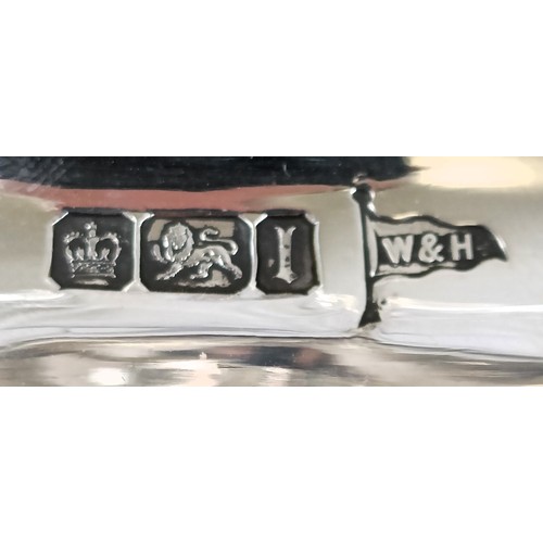 321 - An impressive Edwardian silver and cut glass table centrepiece, of oval form, the base with two lady...