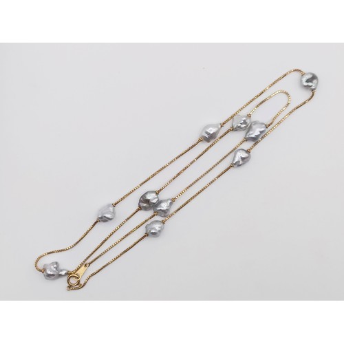 629 - An 18ct gold and baroque pearl set necklace