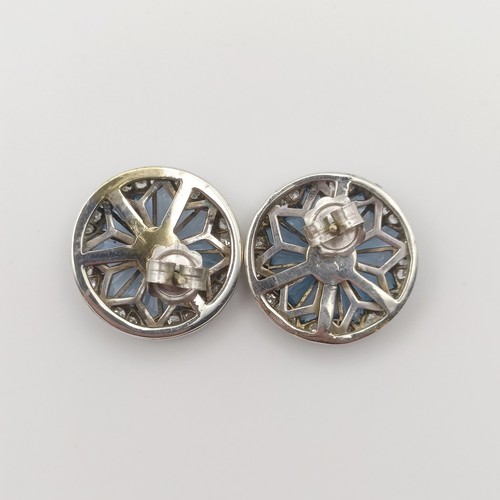 650 - A pair of white coloured metal earrings, set diamonds and blue stones, in a fan design, 2 cm diamete... 