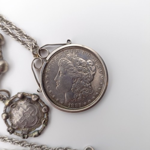 653 - An American dollar, 1885, mounted as a pendant, on a chain, and a Rosary type bracelet (2)