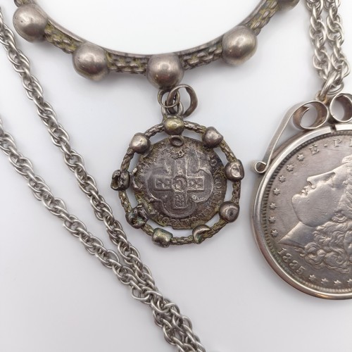 653 - An American dollar, 1885, mounted as a pendant, on a chain, and a Rosary type bracelet (2)