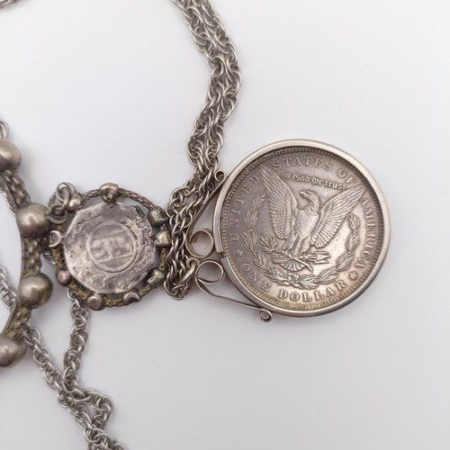 653 - An American dollar, 1885, mounted as a pendant, on a chain, and a Rosary type bracelet (2)