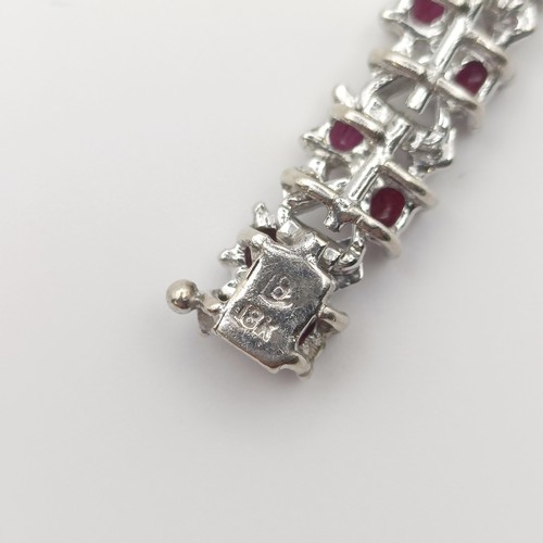 659 - A ruby and diamond bracelet, and a pearl and diamond crossover brooch (2)