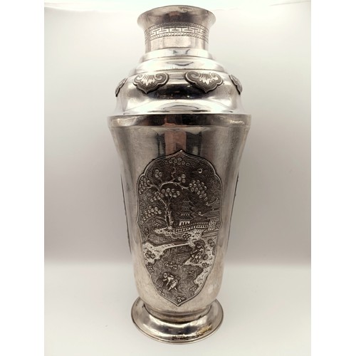 370 - A Continental silver coloured metal cocktail shaker, with chinoiserie style decoration, 23.5 cm high...