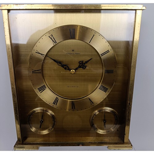 820 - A Tiffany & Co desk timepiece, in a brass case, 23 cm high, a similar clock, three wall sconces,...