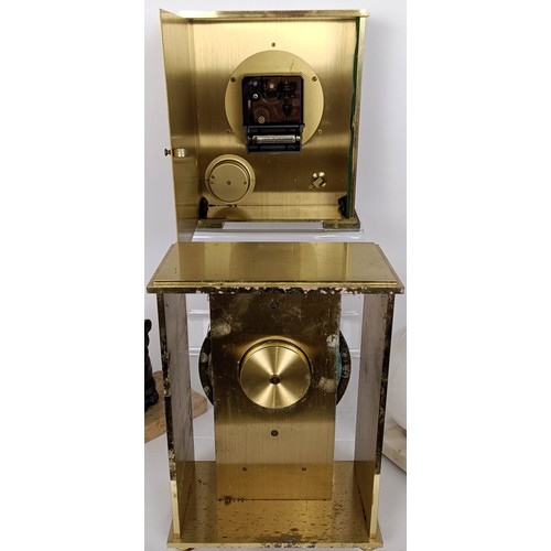 820 - A Tiffany & Co desk timepiece, in a brass case, 23 cm high, a similar clock, three wall sconces,...
