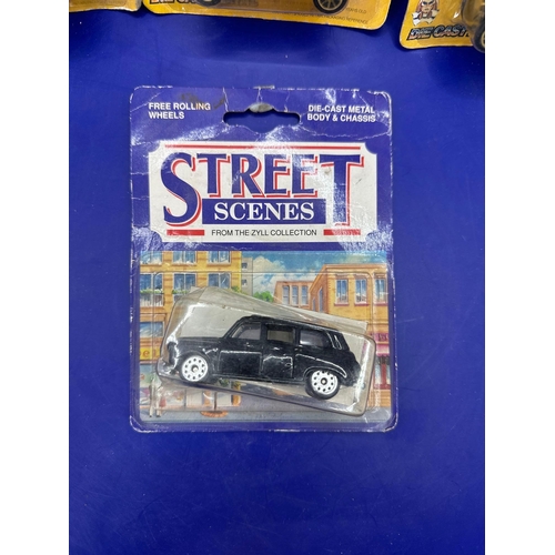 133 - 4 x diecasts on card, one street scenes, black cab and three classics. Item number 30106