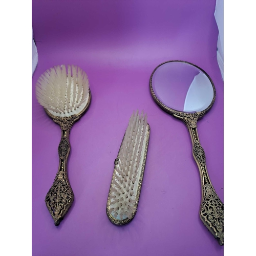 573 - Vintage Antique Brass Vanity Set Comprising Of A Mirror And 2 Brushes With Embroidered Pattern On Ea... 