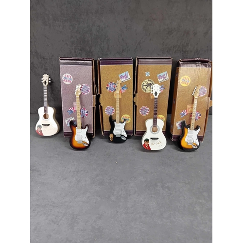 415 - Miniature collectable guitars   2 x Elvis Presley   1 x Jimmy Hendrix   1 x Eric Clapton   1 x Buddy... 