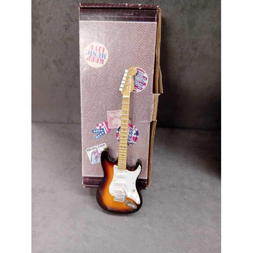 415 - Miniature collectable guitars   2 x Elvis Presley   1 x Jimmy Hendrix   1 x Eric Clapton   1 x Buddy... 