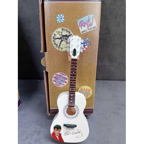 415 - Miniature collectable guitars   2 x Elvis Presley   1 x Jimmy Hendrix   1 x Eric Clapton   1 x Buddy... 