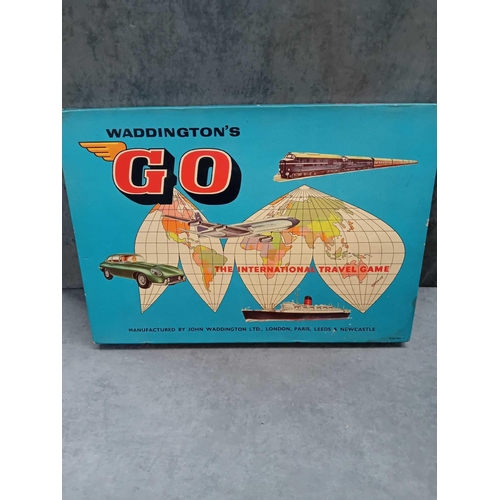 615 - 2 x vintage board games   1 x Waddington go international travel game   1 x escape from colditz