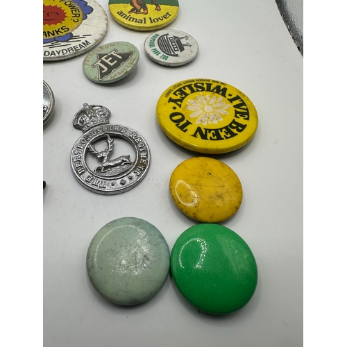 143 - A collection of 20 assorted vintage pins and badges, predominantly mid-20th century tin-plate and en... 