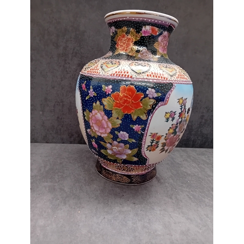 239 - A Mid 20th Century Chinese Famille Rose hand painted porcelain baluster vase. The vase features exte... 