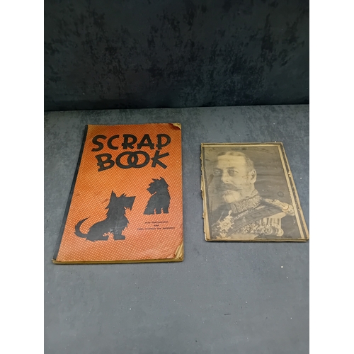 513 - A vintage, orange, spiral-bound scrapbook featuring a stylized 