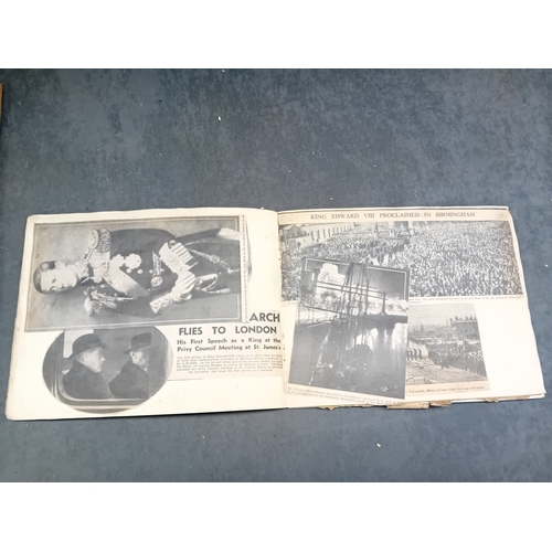 513 - A vintage, orange, spiral-bound scrapbook featuring a stylized 